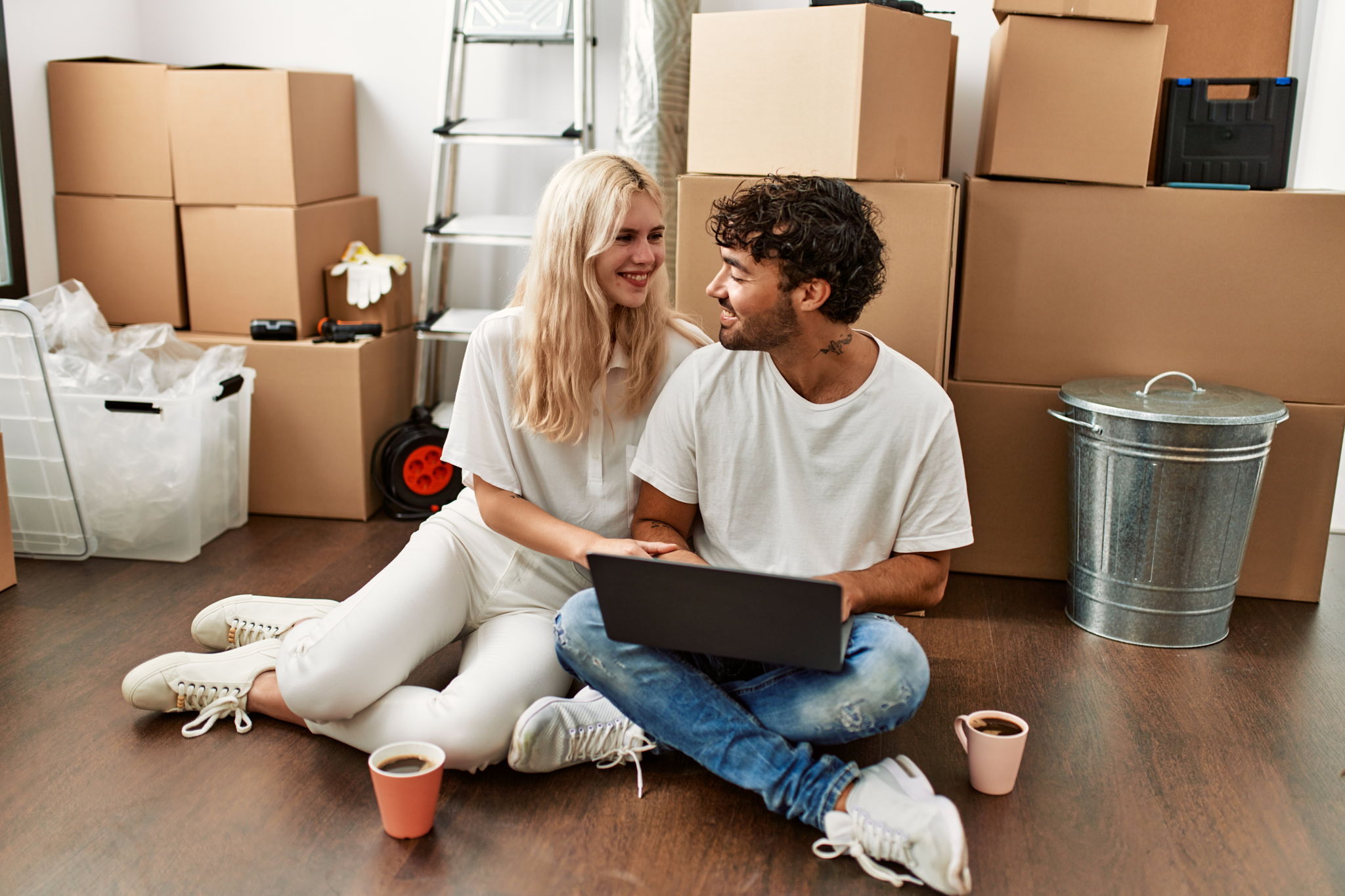 couple sitting in front of moving boxes