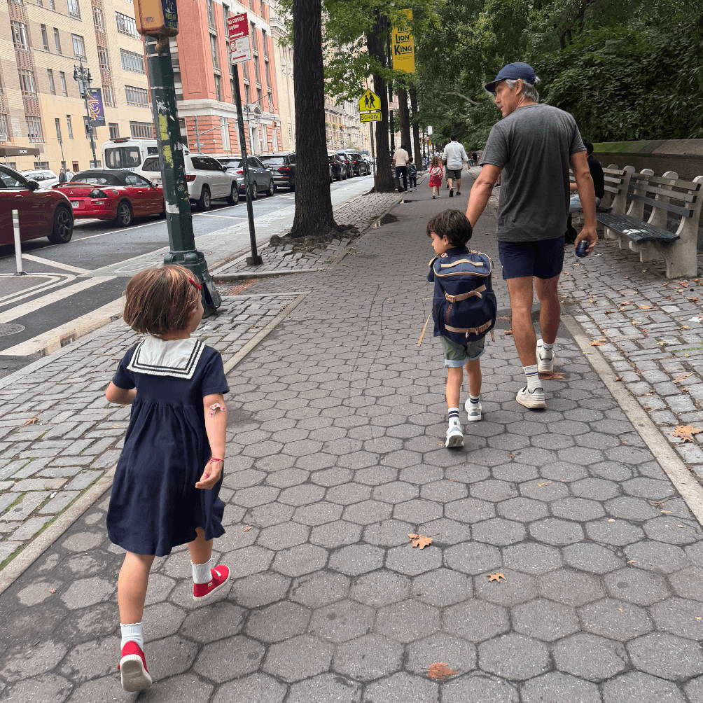 Children walking on the sidewalk.