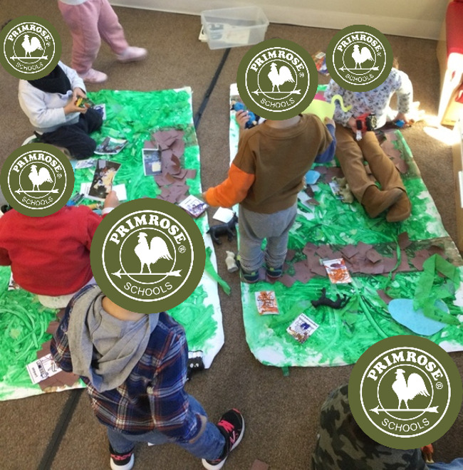 children exploring the town map they made out of recycled materials 