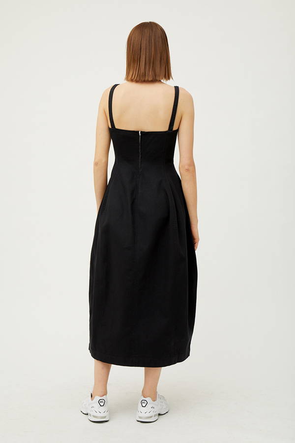 Back of woman wearing black organic cotton dress