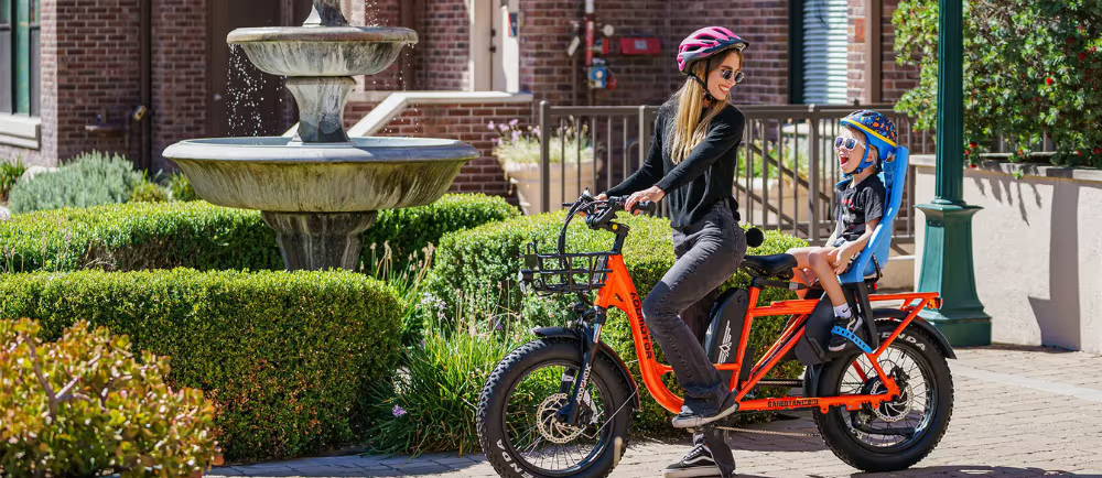 Electric cargo bike with child