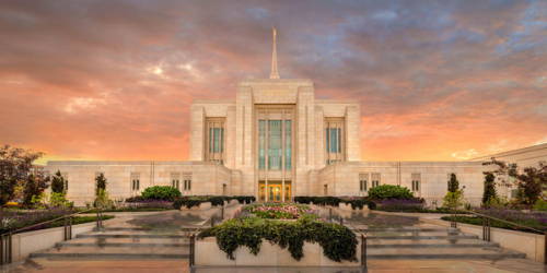 Ogden Temple beneath an orange, pink, and blue sky. 