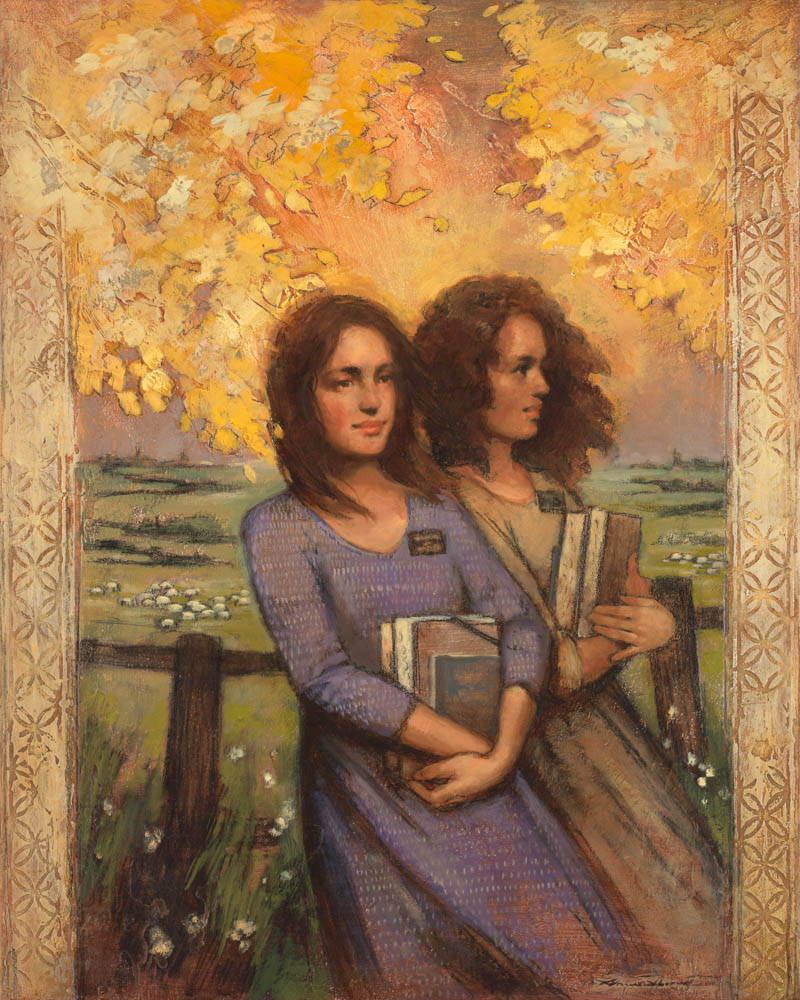 Two sister missionaries standing beneath autumn leaves.