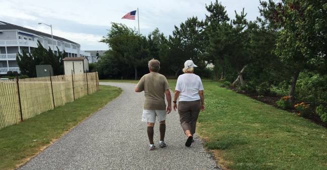 man wearing knee-high compression socks while walking