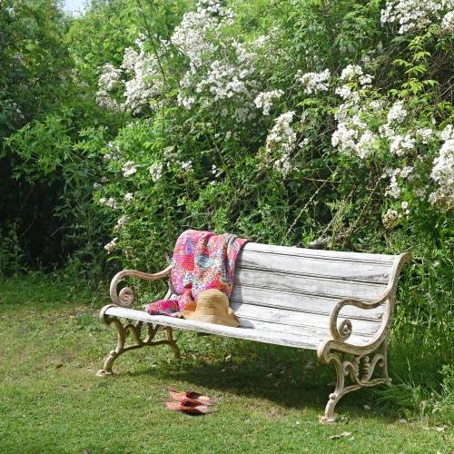 Indian vintage cast iron garden bench in an English garden