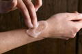 woman applying a body scrub to her skin