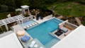 Luxury pool area and outdoor entertaining space with integrated landscape lighting and illuminated architectural features.