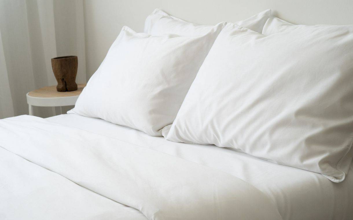white bed sheets with white pillows